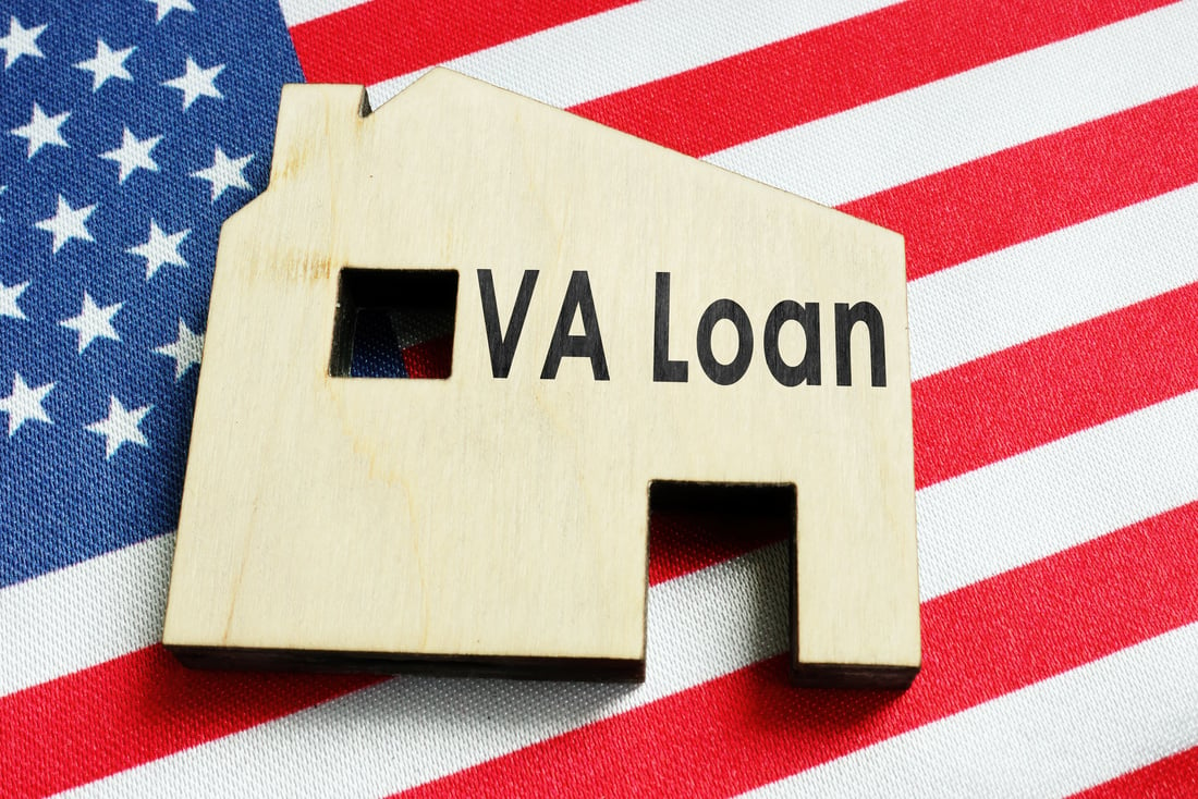 VA loan sign on the home and American flag.